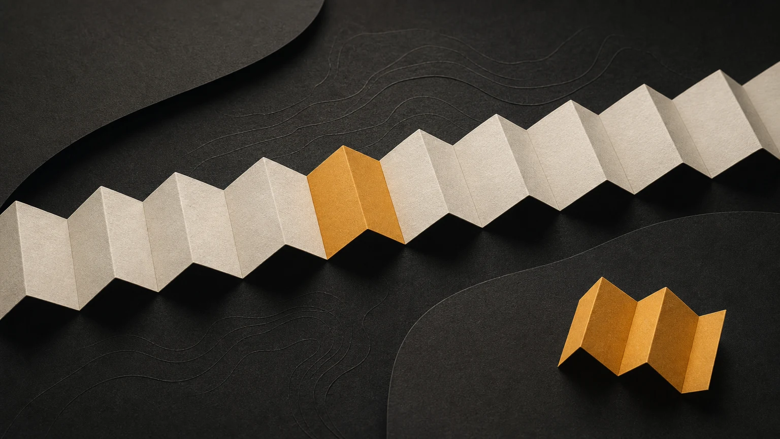 One amber fold interrupts an ivory paper strip and repeats in a separate small piece.